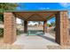 Covered picnic area with table and benches, perfect for outdoor gatherings at 7244 S Sunrise Way, Buckeye, AZ 85326