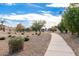 A paved pathway winds through a well-maintained desert landscape at 7244 S Sunrise Way, Buckeye, AZ 85326