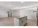 Modern kitchen with white cabinets, an island and tile flooring at 7504 S Sundown Ct, Buckeye, AZ 85326