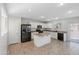 Modern kitchen with white cabinets, an island, and stainless steel appliances at 7504 S Sundown Ct, Buckeye, AZ 85326