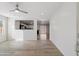 Bright and airy living room with wood-look flooring and an open floor plan at 7504 S Sundown Ct, Buckeye, AZ 85326