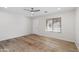 Living room with wood-look flooring and access to exterior at 7504 S Sundown Ct, Buckeye, AZ 85326