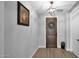 Bright entryway with wood door, tile floors and picture at 7563 E Plata Ave, Mesa, AZ 85212