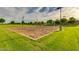 Sand volleyball court with lights and green grass at 7563 E Plata Ave, Mesa, AZ 85212