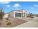 View of the home's side elevation, showcasing the garage and landscaping at 8448 W Candlewood Way, Florence, AZ 85132