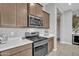 Kitchen with gas stove, microwave, and wooden cabinets at 8448 W Candlewood Way, Florence, AZ 85132