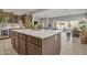 Eat-in kitchen with island, white countertops, and dark cabinetry at 8448 W Candlewood Way, Florence, AZ 85132