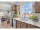 Modern kitchen with stainless steel appliances and white countertops at 8448 W Candlewood Way, Florence, AZ 85132