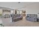 Open concept living room with grey sofas and kitchen views at 8448 W Candlewood Way, Florence, AZ 85132