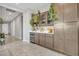 Home wet bar with wooden cabinets and wine storage at 8448 W Candlewood Way, Florence, AZ 85132