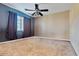 Bright bedroom with carpeted floor, ceiling fan, and window coverings at 9022 W Ross Ave, Peoria, AZ 85382