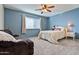 Light and airy bedroom with a comfortable bed and sitting area at 9022 W Ross Ave, Peoria, AZ 85382