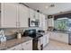 View of kitchen with granite countertops and stainless steel appliances at 9022 W Ross Ave, Peoria, AZ 85382