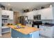 Kitchen with white cabinets, butcher block island, and stainless steel appliances at 9022 W Ross Ave, Peoria, AZ 85382