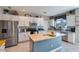 Kitchen with white cabinets, butcher block island, and stainless steel appliances at 9022 W Ross Ave, Peoria, AZ 85382