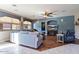 Living Room features hardwood floors, sectional sofa, and ceiling fan at 9022 W Ross Ave, Peoria, AZ 85382