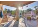 Covered patio with comfortable seating and sunlit views of pool at 9022 W Ross Ave, Peoria, AZ 85382