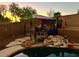 Backyard oasis with a pergola, pool, and waterfall feature at 9022 W Ross Ave, Peoria, AZ 85382