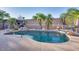 Relaxing kidney-shaped pool with waterfall feature, surrounded by palm trees and patio furniture at 9022 W Ross Ave, Peoria, AZ 85382