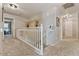 Upstairs hallway with white railing and carpet flooring at 9022 W Ross Ave, Peoria, AZ 85382