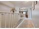 Upstairs hallway with white railing and carpet flooring at 9022 W Ross Ave, Peoria, AZ 85382