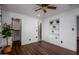 Bedroom with dark wood floors, ceiling fan, and built-in shelving at 903 W Mackenzie Dr, Phoenix, AZ 85013