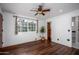 Bright bedroom with dark wood floors and ceiling fan at 903 W Mackenzie Dr, Phoenix, AZ 85013