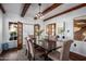 Bright dining room features a dark wood table, six chairs, and access to laundry at 903 W Mackenzie Dr, Phoenix, AZ 85013