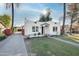 White stucco house with a grassy yard and brick driveway at 903 W Mackenzie Dr, Phoenix, AZ 85013