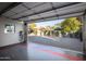 Garage with open door revealing a paved backyard and mature trees at 903 W Mackenzie Dr, Phoenix, AZ 85013