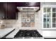 Modern kitchen with stainless steel appliances and custom tile at 903 W Mackenzie Dr, Phoenix, AZ 85013