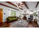 Living room with hardwood floors, fireplace, and ceiling beams at 903 W Mackenzie Dr, Phoenix, AZ 85013