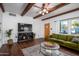 Living area with hardwood floors, large TV and green couch at 903 W Mackenzie Dr, Phoenix, AZ 85013