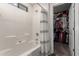 Bathroom with a bathtub, shower, and storage closet at 9823 E Escondido Ave, Mesa, AZ 85208