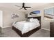 Serene bedroom featuring a comfortable bed and ceiling fan at 9823 E Escondido Ave, Mesa, AZ 85208