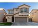 Two-story house with gray garage door and landscaping at 9823 E Escondido Ave, Mesa, AZ 85208