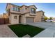 Two-story house with a gray garage door and artificial turf at 9823 E Escondido Ave, Mesa, AZ 85208