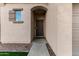 Front entrance with a metal security door and walkway at 9823 E Escondido Ave, Mesa, AZ 85208