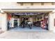 Garage featuring two motorcycles, a seating area, and a well-organized workspace at 9823 E Escondido Ave, Mesa, AZ 85208