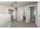 Upstairs hallway with carpet and access to bedrooms and bathroom at 9823 E Escondido Ave, Mesa, AZ 85208