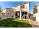 Two-story house with backyard patio, string lights, and grass at 9823 E Escondido Ave, Mesa, AZ 85208