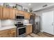 Modern kitchen with stainless steel appliances and wood cabinets at 9823 E Escondido Ave, Mesa, AZ 85208