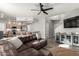 Open living area with leather sectional sofa, hardwood floors, and modern kitchen island at 9823 E Escondido Ave, Mesa, AZ 85208