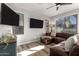 Living room with L-shaped sectional sofa and wood-look floors at 9823 E Escondido Ave, Mesa, AZ 85208