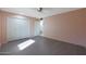 Bedroom with gray flooring, double closet and access to bathroom at 10240 W Oak Ridge Dr, Sun City, AZ 85351