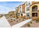 Row of townhouses with well-manicured landscaping and sidewalks at 1255 N Arizona Ave # 1038, Chandler, AZ 85225