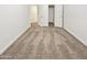 Well-lit bedroom with carpet and double door closet at 13033 W Avalon Dr, Avondale, AZ 85392