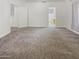 Spacious bedroom with plush carpeting and access to a bathroom at 13033 W Avalon Dr, Avondale, AZ 85392