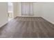 Well-lit bedroom with neutral carpeting and a view of the bathroom at 13033 W Avalon Dr, Avondale, AZ 85392