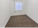 Bright bedroom featuring carpeted floor and window at 13033 W Avalon Dr, Avondale, AZ 85392